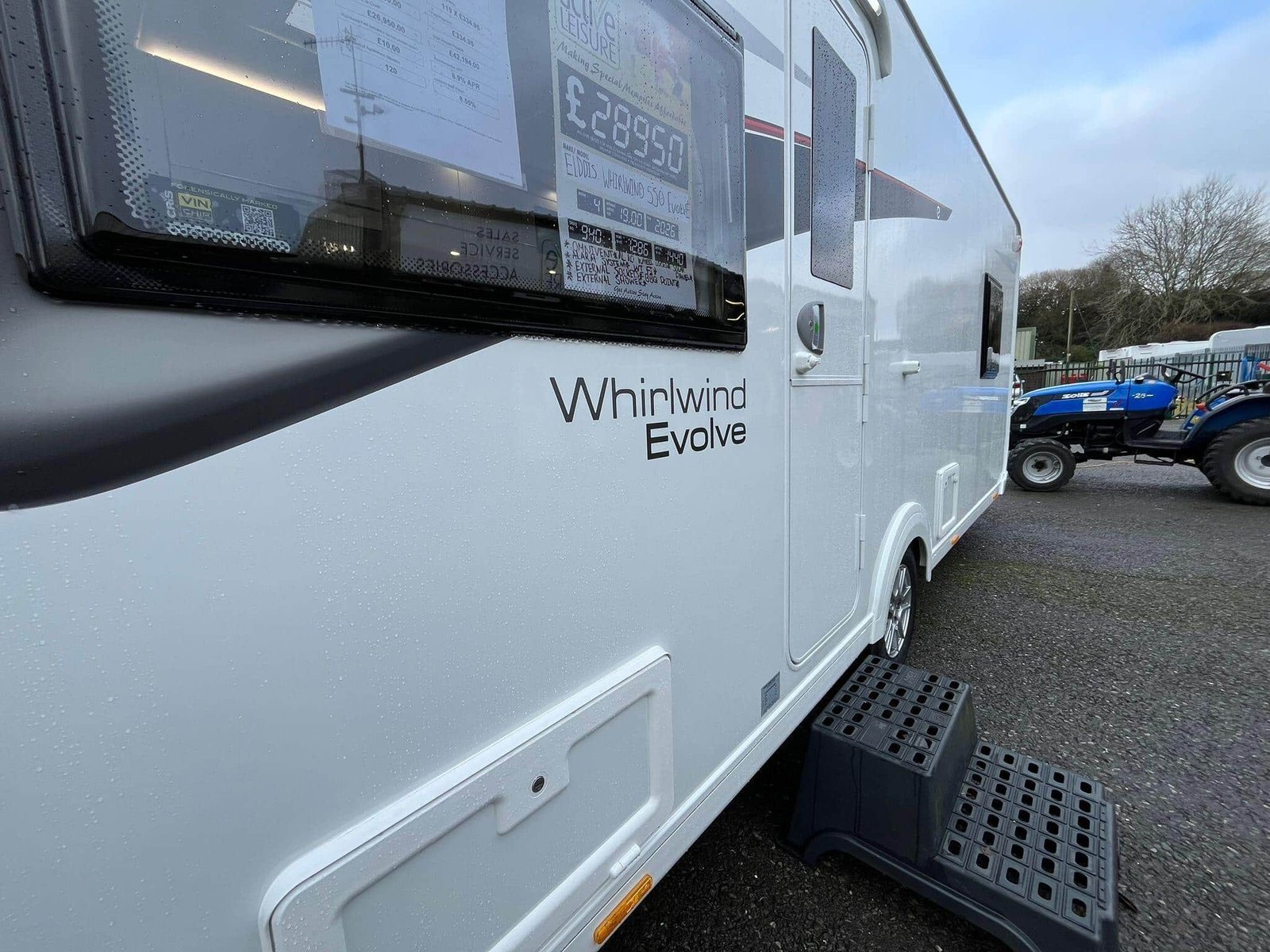A caravan exterior being carefully inspected before winter storage
