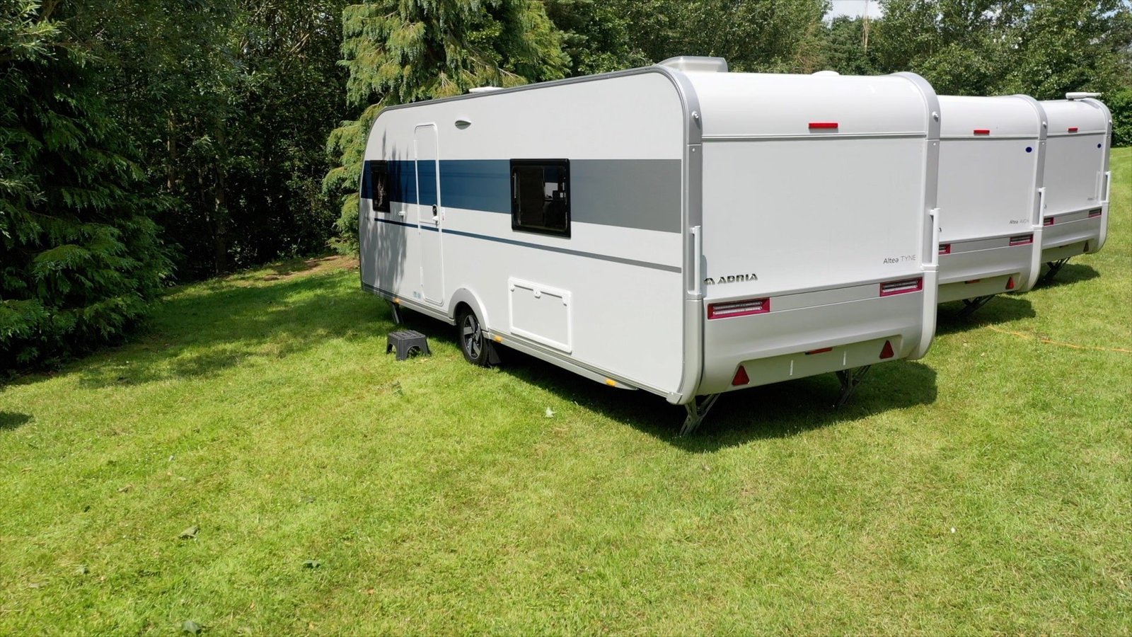 A touring caravan pitched in attractive countryside during spring