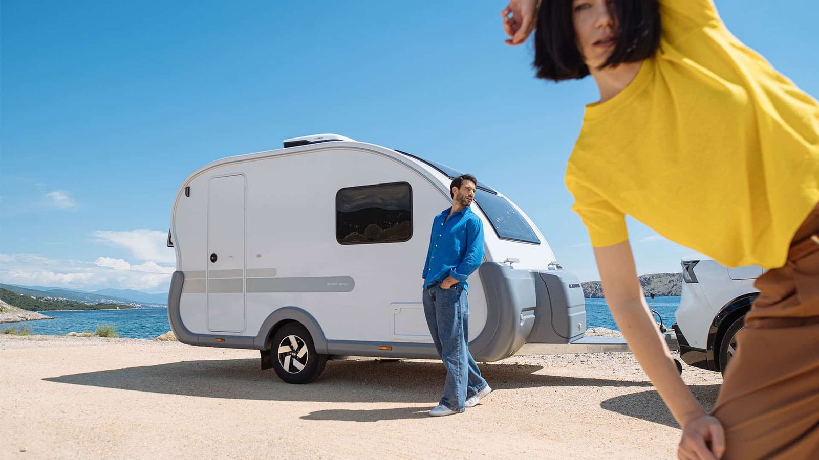 A touring caravan set up at a peaceful countryside campsite